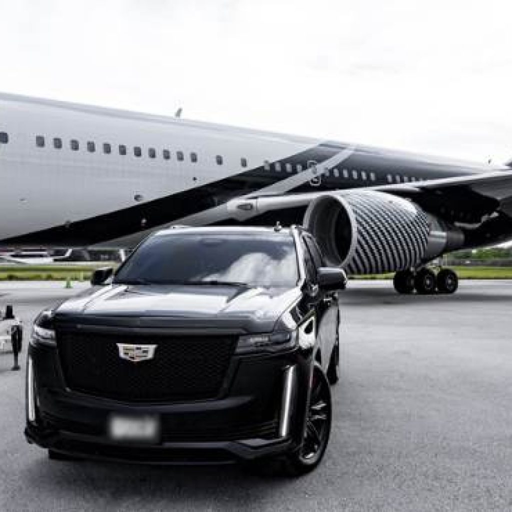 Cadillac Escalade SUV near an aircraft